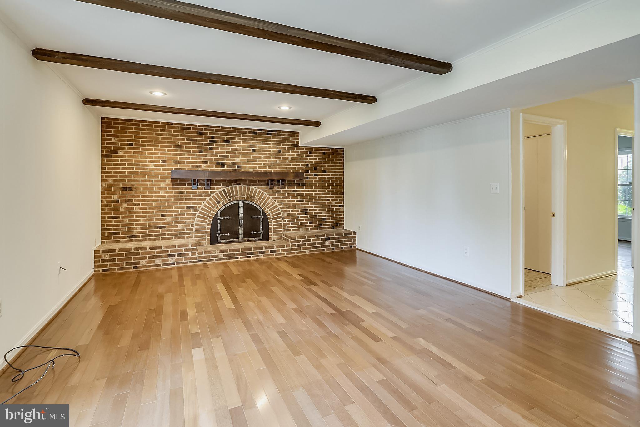 14825 Notley Road Silver Spring, MD 20905 - Photo 17 of 60 Family room with brick wall