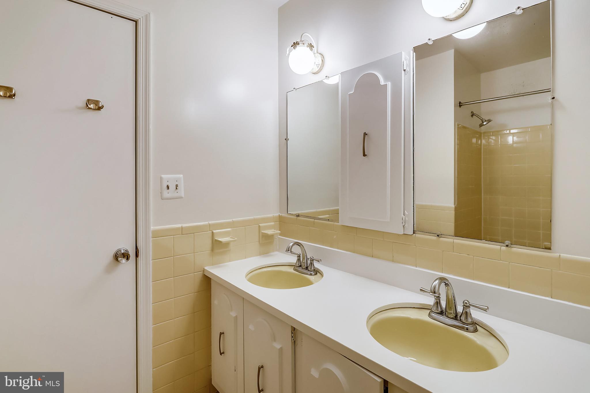 14825 Notley Road Silver Spring, MD 20905 - Photo 37 of 60 Upstairs hall bath with double sinks and tub