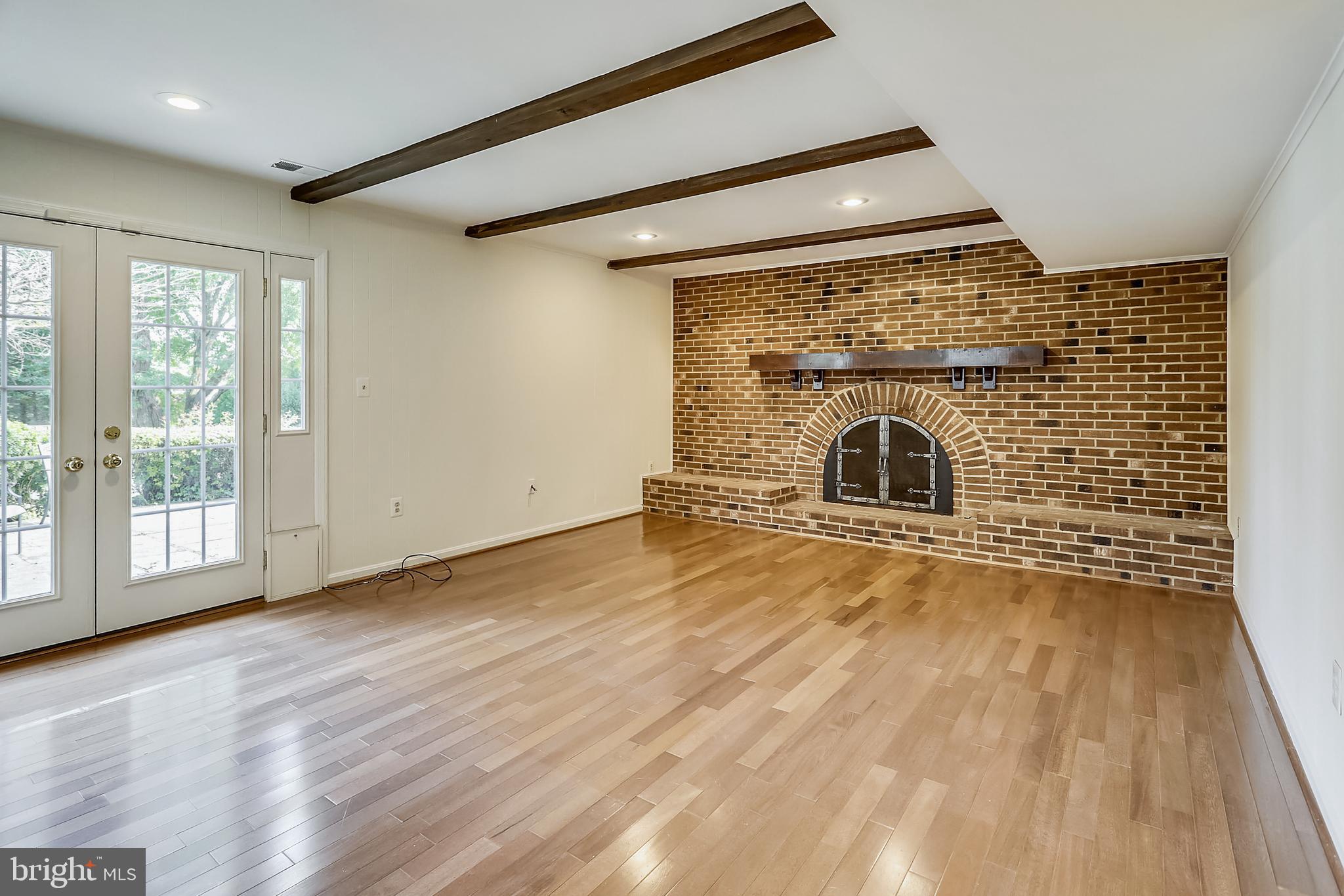 14825 Notley Road Silver Spring, MD 20905 - Photo 8 of 60 Family room with fireplace and beamed ceiling