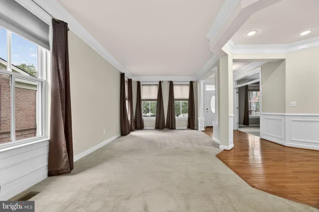 a kitchen with stainless steel appliances granite countertop wooden floors and white cabinets