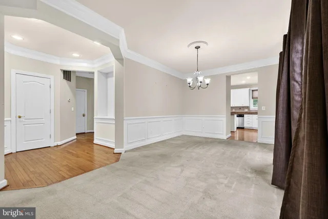 a view of an empty room with window and fireplace