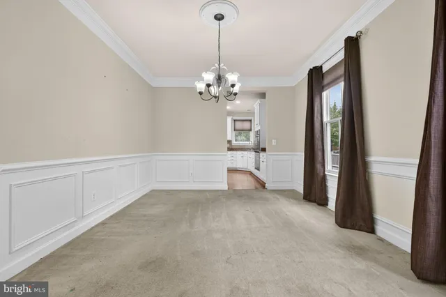 a view of an empty room with window and fireplace
