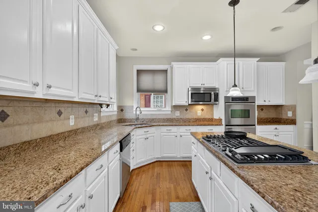a spacious bathroom with a double vanity sink a mirror and a shower