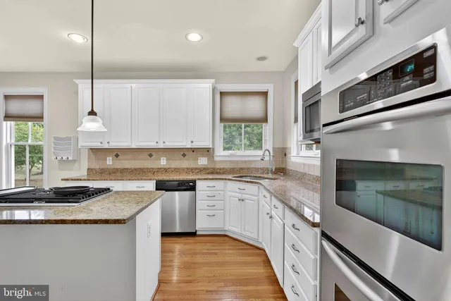 a view of an empty room with a kitchen
