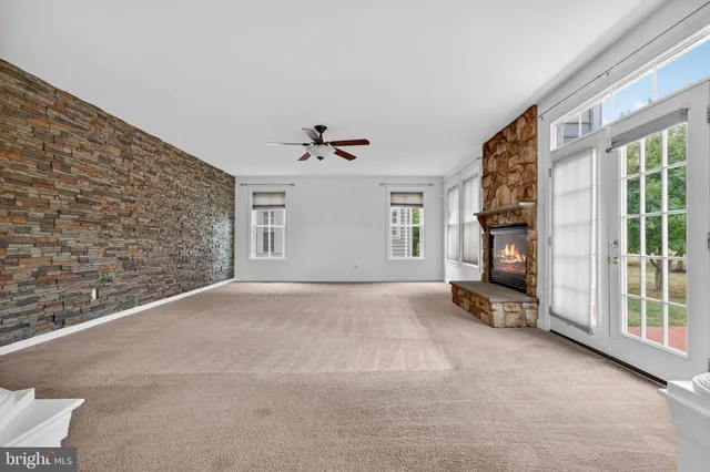 a view of an empty room with a kitchen