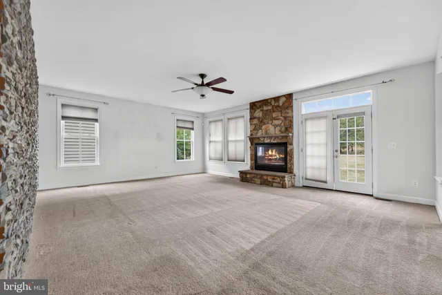 a view of an empty room with a ceiling fan
