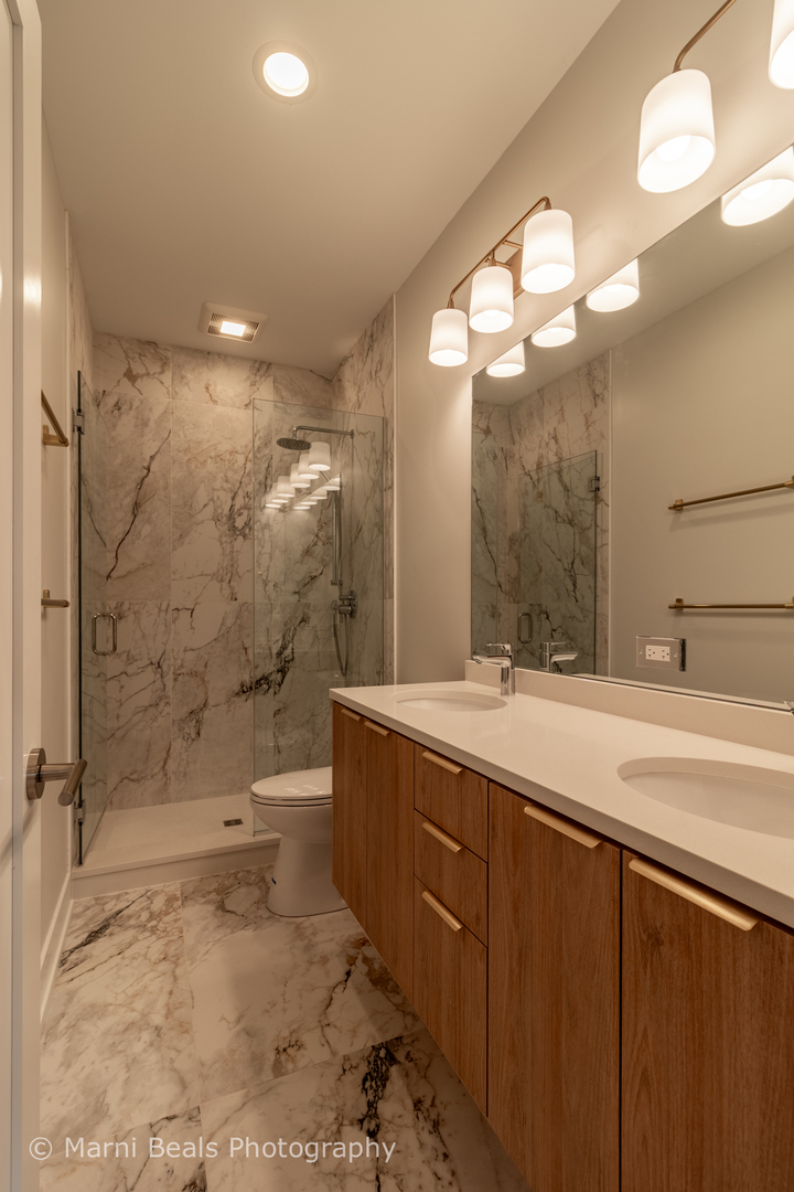 12 West 44th Street Chicago, IL 60632 - Photo 12 of 29 a bathroom with a double vanity sink mirror and shower