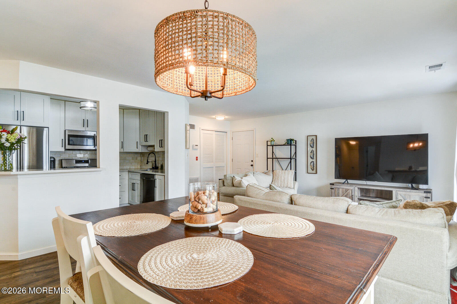 1 White Oak Court Howell, NJ 07731 - Photo 6 of 13 a dining room with wooden floor a chandelier a wooden table and chairs