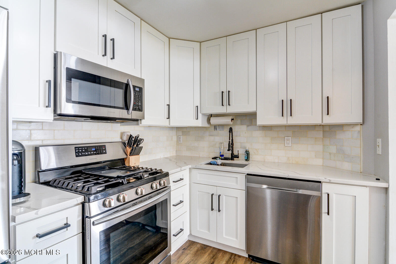 1 White Oak Court Howell, NJ 07731 - Photo 7 of 13 a kitchen with white cabinets and appliances