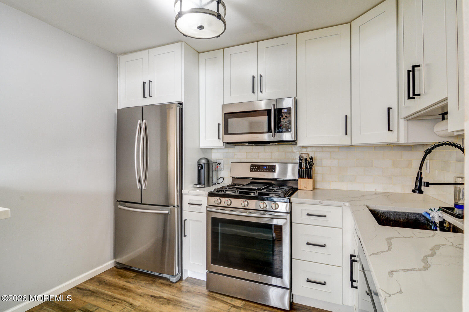 1 White Oak Court Howell, NJ 07731 - Photo 9 of 13 a kitchen with stainless steel appliances a refrigerator stove and microwave