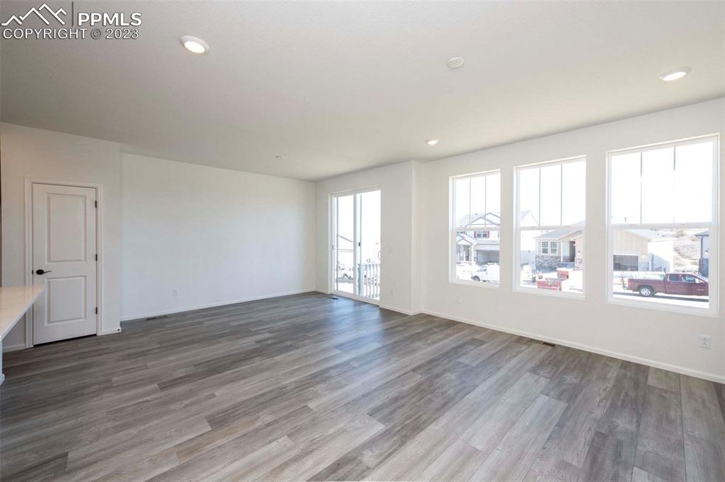 2045 Peachleaf Loop Castle Rock, CO 80108 - Photo 11 of 21 an empty room with wooden floor and windows