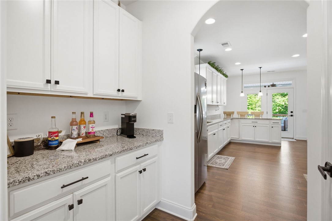 525 16th Circle Walhalla, SC 29691 - Photo 12 of 50 This modern kitchen features white cabinetry and light granite countertops, creating a bright and inviting space.