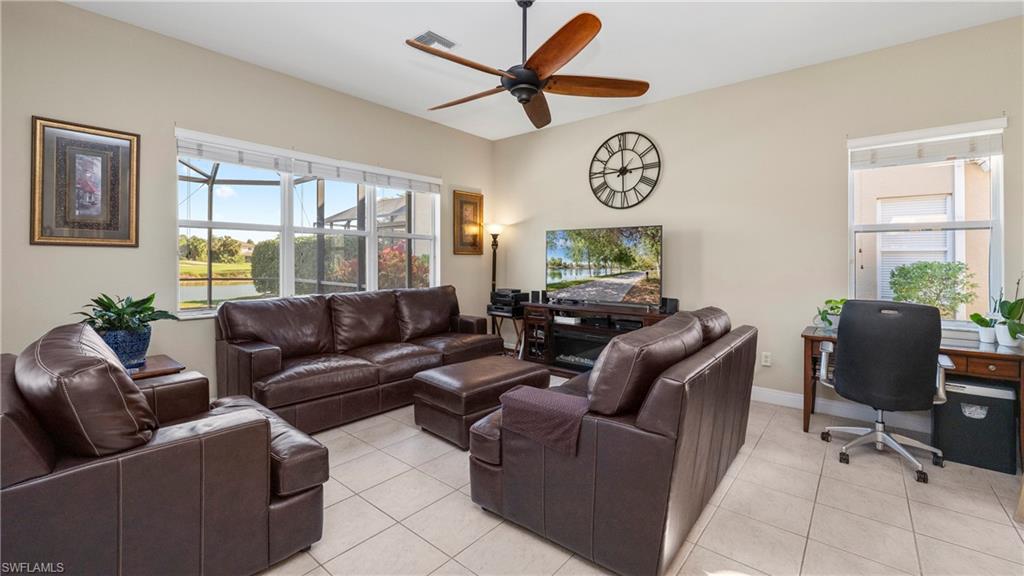 1730 Sarazen Place Naples, FL 34120 - Photo 21 of 50 a living room with furniture and a large window