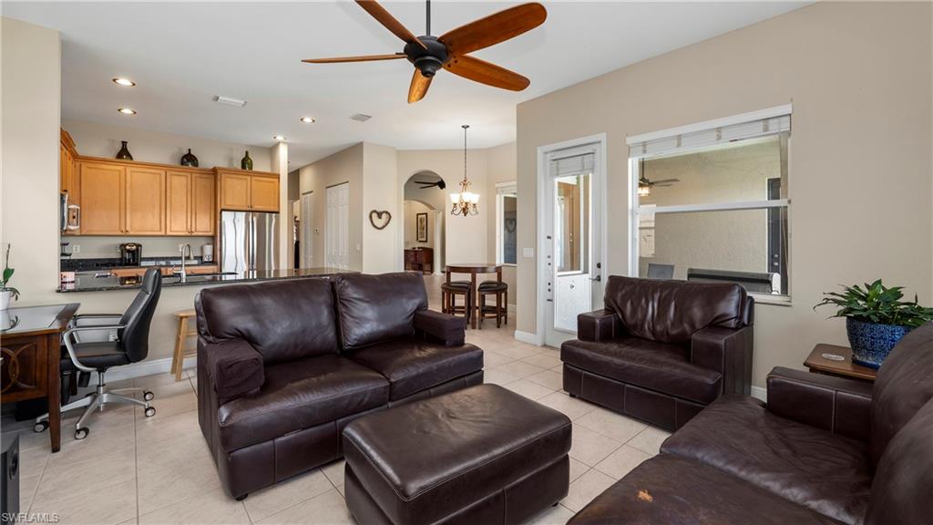 1730 Sarazen Place Naples, FL 34120 - Photo 22 of 50 a living room with furniture kitchen view and a potted plant