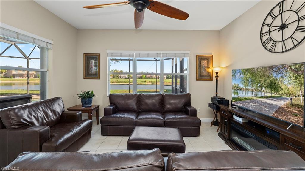 1730 Sarazen Place Naples, FL 34120 - Photo 23 of 50 a living room with furniture and a large window
