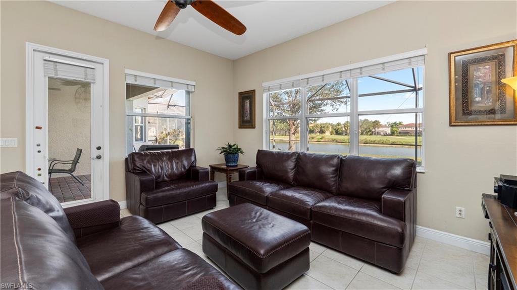 1730 Sarazen Place Naples, FL 34120 - Photo 24 of 50 a living room with furniture and a large window