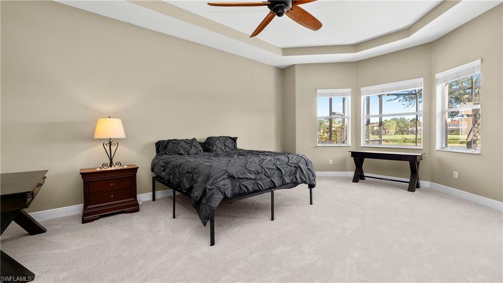 1730 Sarazen Place Naples, FL 34120 - Photo 27 of 50 a bedroom with a bed dresser and a window