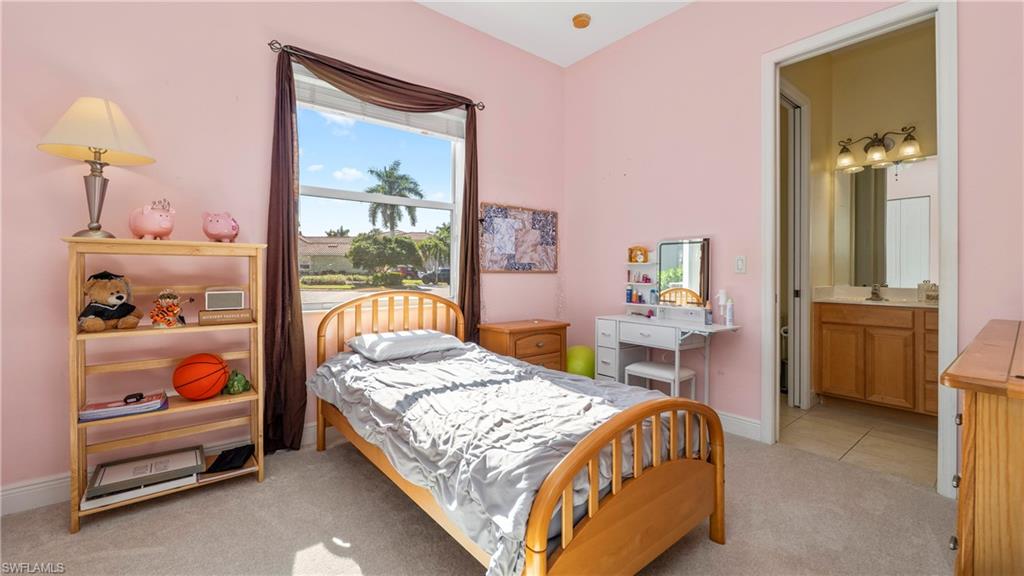 1730 Sarazen Place Naples, FL 34120 - Photo 31 of 50 a bedroom with a bed and a window