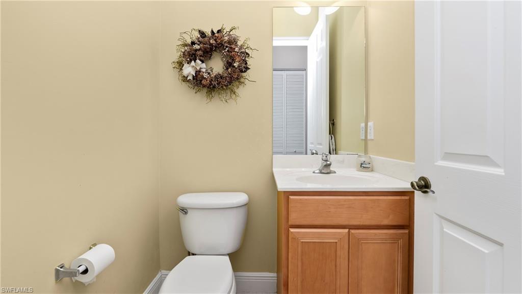 1730 Sarazen Place Naples, FL 34120 - Photo 33 of 50 a bathroom with a toilet sink and mirror