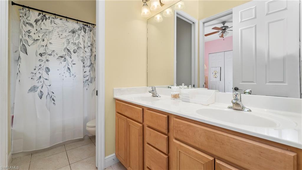 1730 Sarazen Place Naples, FL 34120 - Photo 34 of 50 a bathroom with a double vanity sink mirror and double