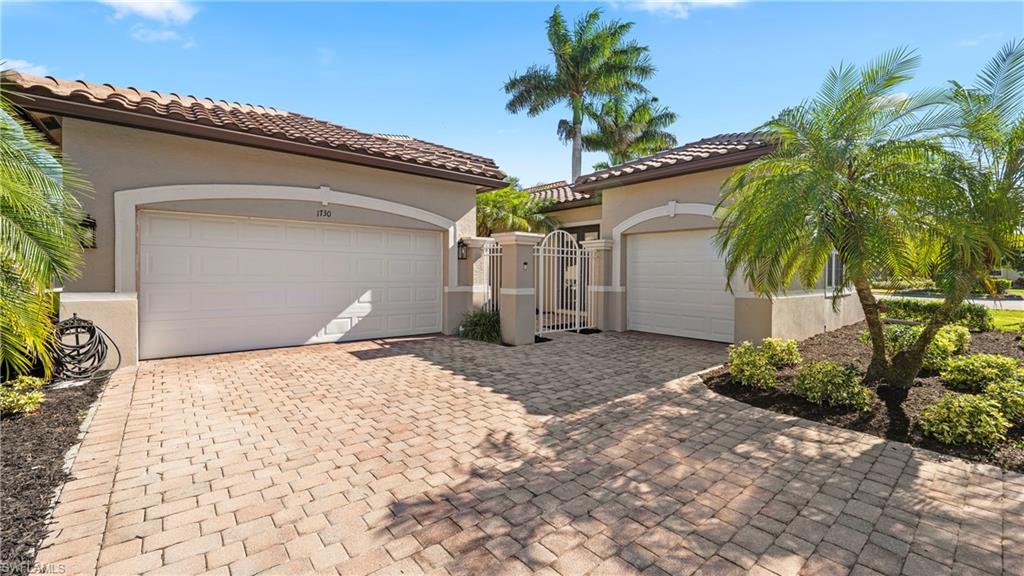 1730 Sarazen Place Naples, FL 34120 - Photo 4 of 50 a house with a yard and a garage