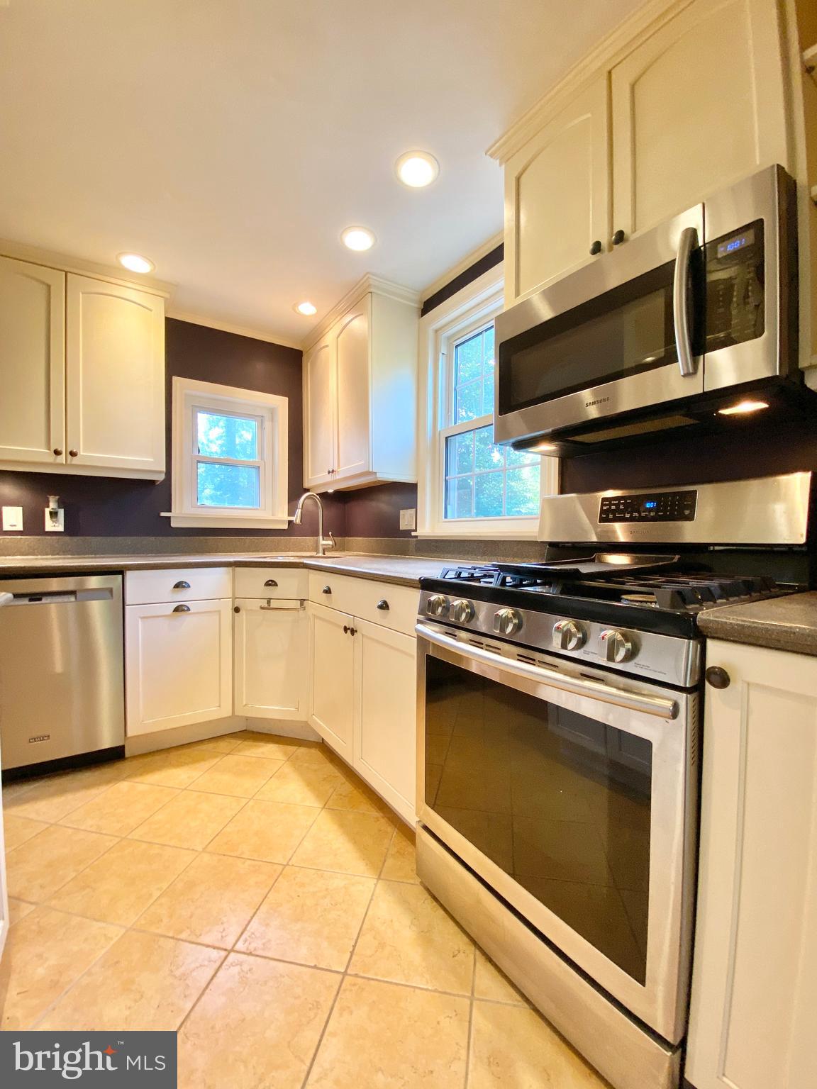26 Hurst Road Wilmington, DE 19803 - Photo 12 of 74 a kitchen with stainless steel appliances granite countertop a stove a sink and a microwave