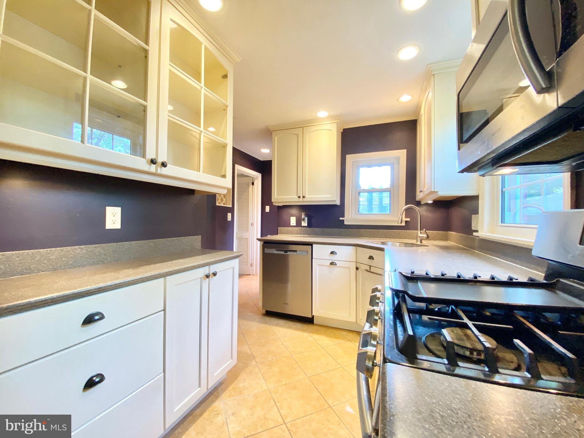 26 Hurst Road Wilmington, DE 19803 - Photo 20 of 74 a kitchen with stainless steel appliances granite countertop a stove a sink and a microwave