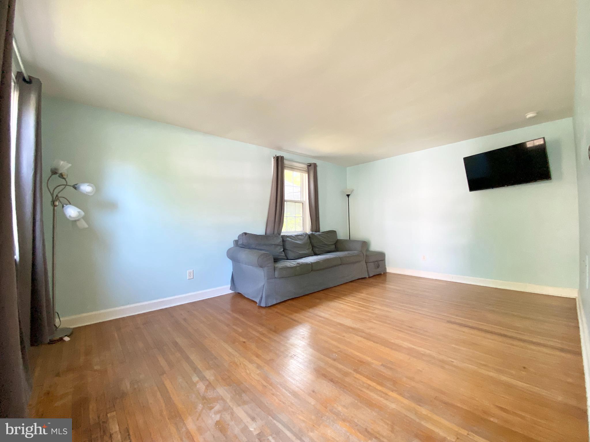26 Hurst Road Wilmington, DE 19803 - Photo 46 of 74 a view of an empty room with wooden floor and a window