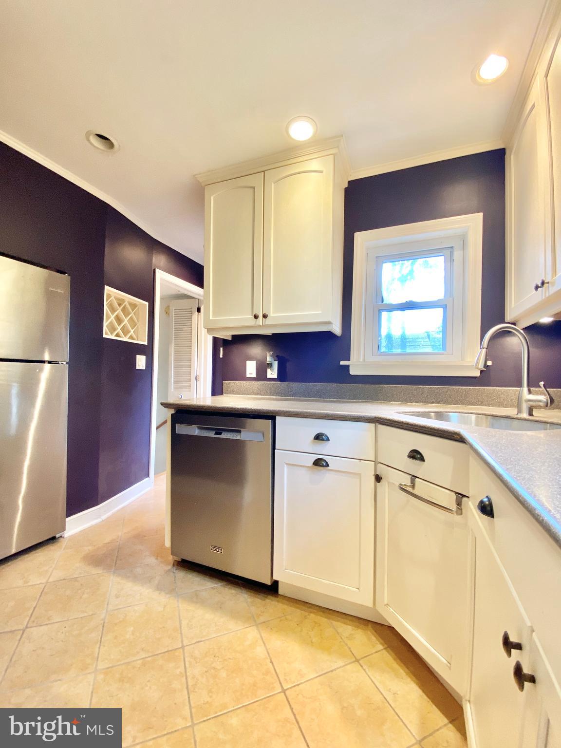 26 Hurst Road Wilmington, DE 19803 - Photo 54 of 74 a kitchen with stainless steel appliances granite countertop a sink and a stove top oven