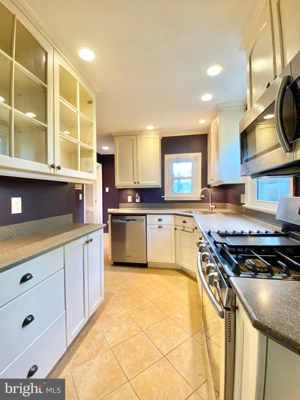 26 Hurst Road Wilmington, DE 19803 - Photo 6 of 74 a kitchen with stainless steel appliances granite countertop a stove a sink and a microwave