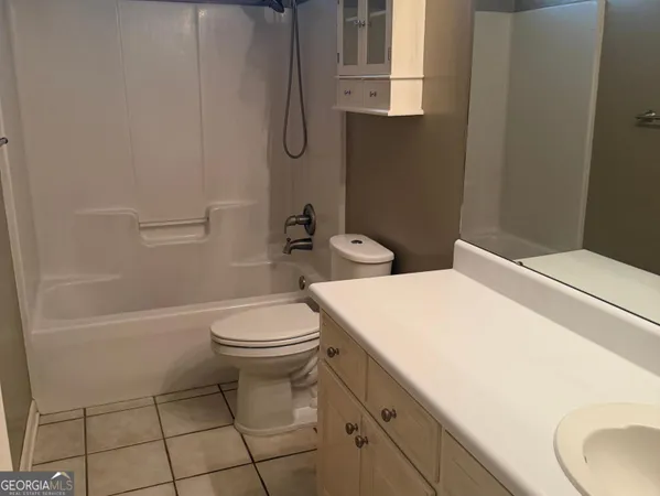 a white toilet sitting next to a white tub