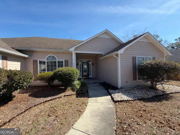a front view of a house with a yard