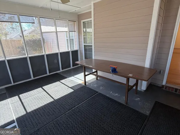 a reading room with wooden floor and furniture