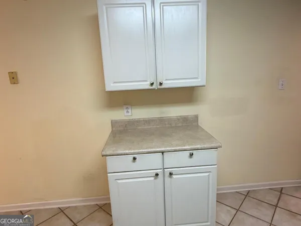 a view of a kitchen with white cabinets