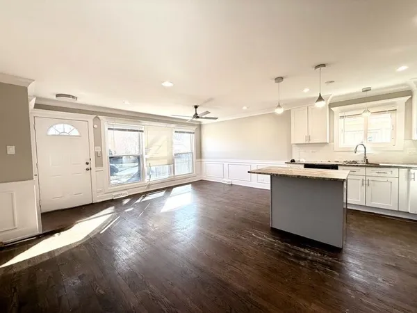 a large kitchen with lots of counter space wooden floor and appliances