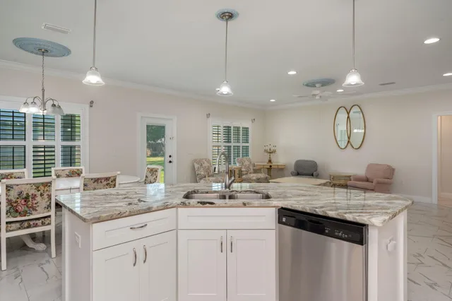 a kitchen with center island cabinets and a chandelier