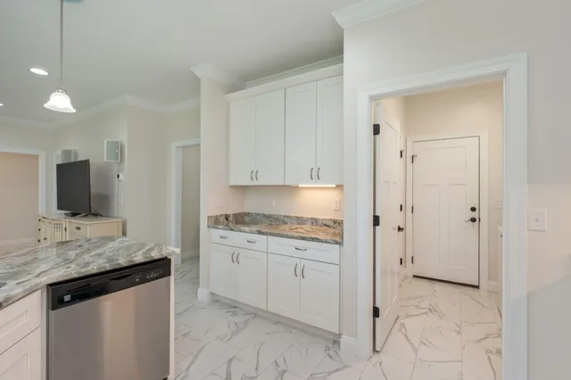a spacious bathroom with a granite countertop sink a mirror and a bathtub