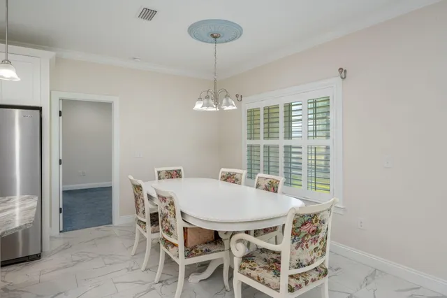 a view of a dining room with furniture window and chandelier