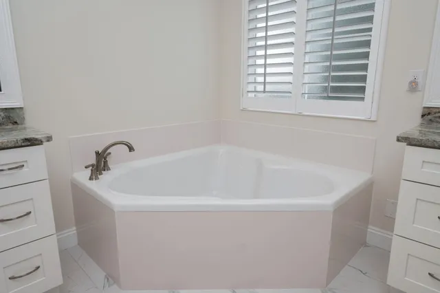 a white bath tub sitting in a bathroom