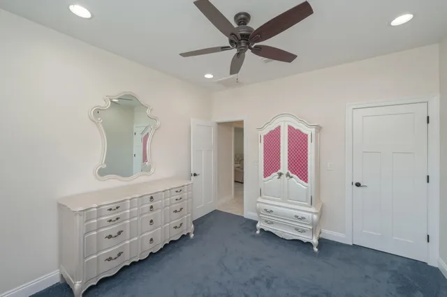 a bedroom with a bed a chandelier and a window