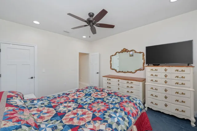 a bathroom with a granite countertop toilet a sink and a mirror
