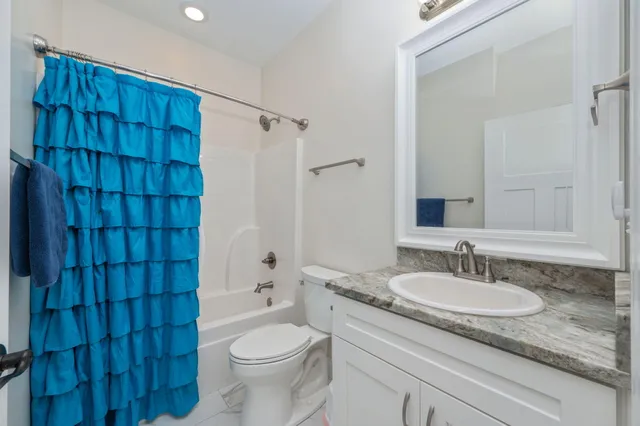 a bathroom with a bathtub a toilet and a shower