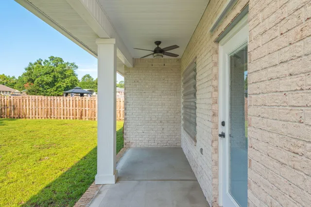 a view of a swimming pool with a big yard and large trees