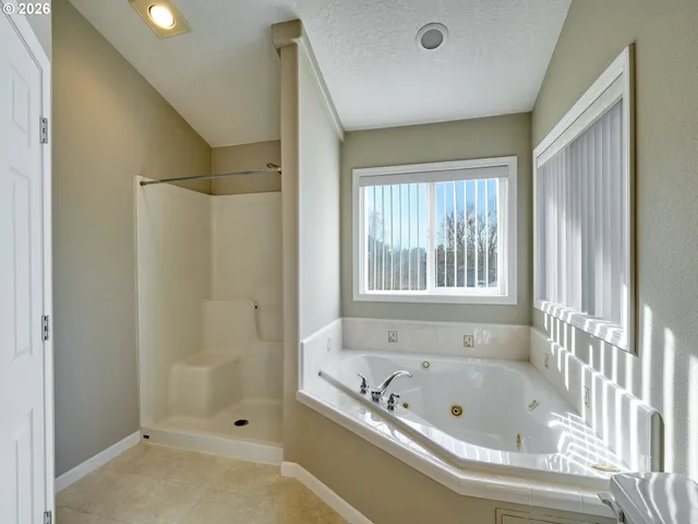 a bathroom with a tub and a shower