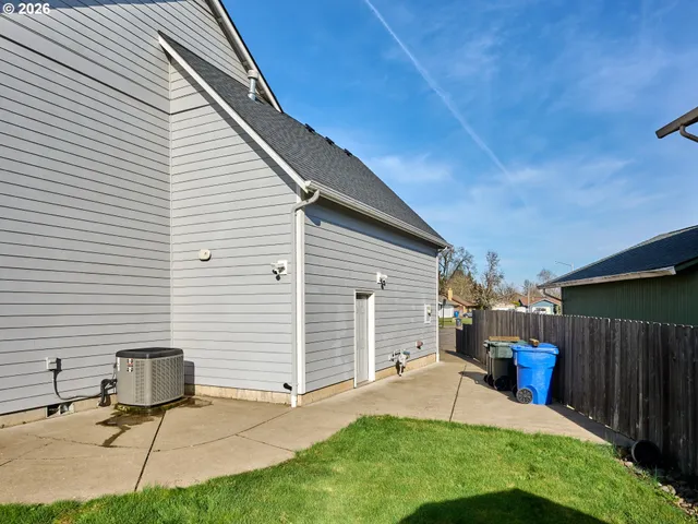 a view of a backyard with table and chairs and a barbeque