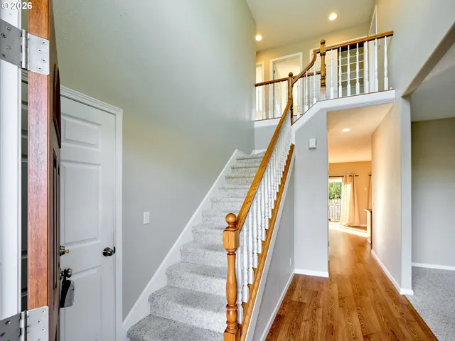 a view of an entryway with wooden floor and stairs