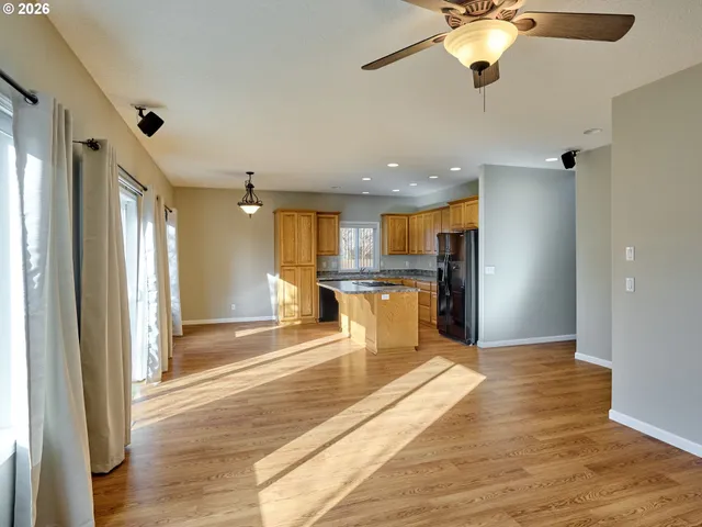 a view of kitchen with refrigerator and window