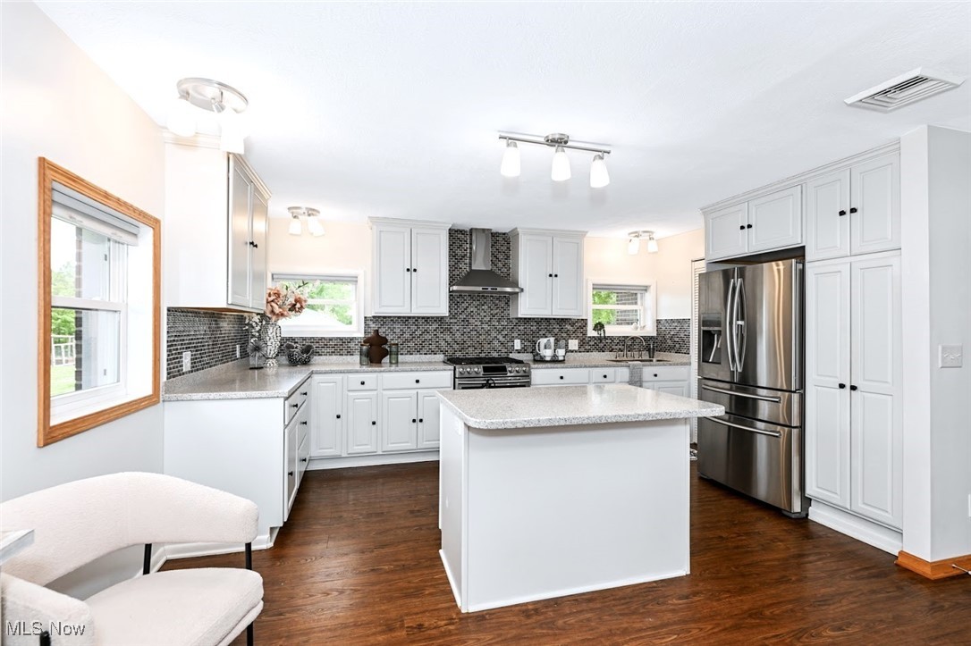 4597 Rock Cut Road Barberton, OH 44203 - Photo 15 of 44 *COMPLETELY REMODELED, EXTENDED KITCHEN W/WHITE CABINETS, SOFT CLOSE DRAWERS, PULL OUT DRAWERS, PANTRY, ISLAND WITH BREAKFAST BAR, MOSAIC TILE BACKSPLASH, TONS OF LIGHTING, STAINLESS STEEL APPLIANCES ~