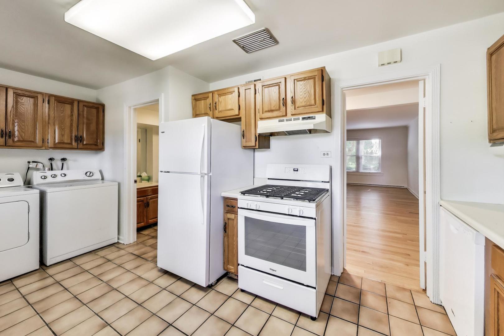 419 3rd Street Wilmette, IL 60091 - Photo 5 of 16 a kitchen with a refrigerator a stove top oven and cabinets