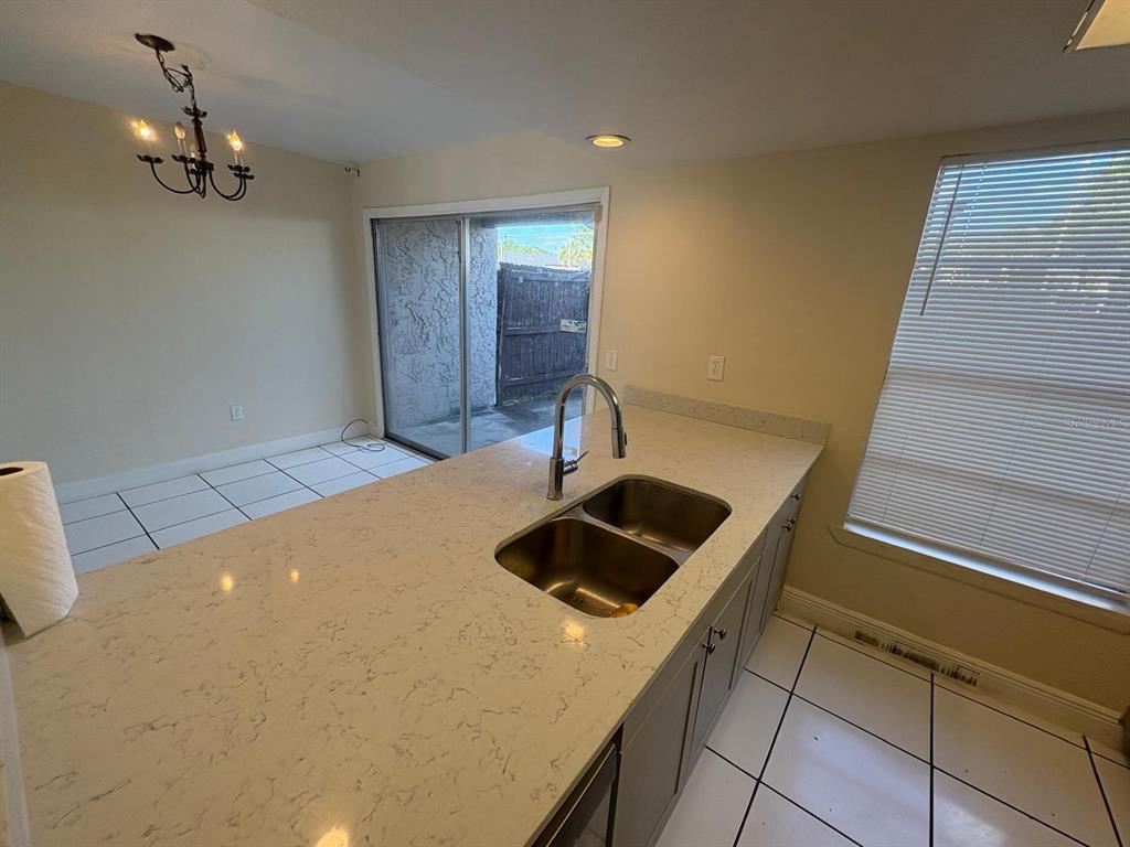 4033 Henley Road, Unit 1707 Orlando, FL 32839 - Photo 46 of 66 a kitchen with a sink a stove and cabinets